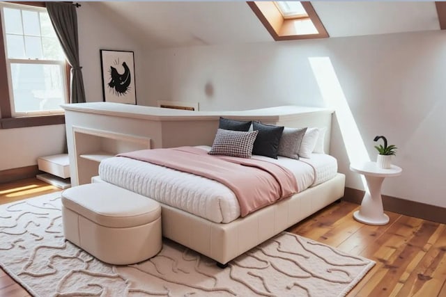 145 Robie St W, Saint Paul, MN 55107 - bedroom with vaulted ceiling, a skylight, hardwood / wood-style flooring, and baseboards