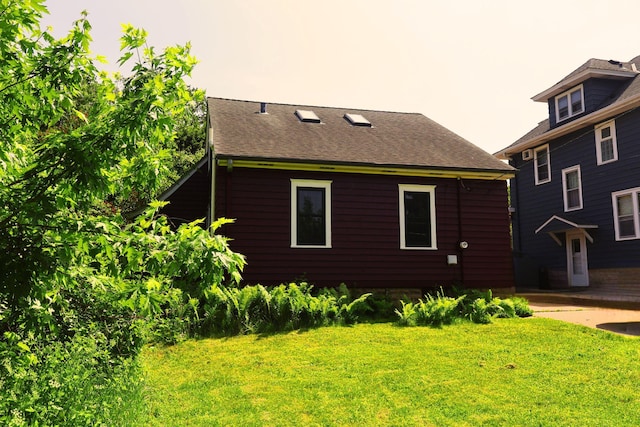 145 Robie St W, Saint Paul, MN 55107 - view of home's exterior featuring a yard and roof with shingles