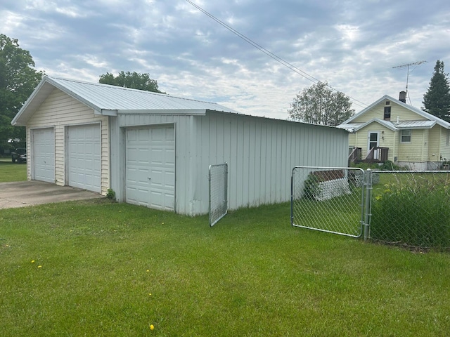 207 Cook St, Palisade, MN 56469 - view of side of property with a detached garage, an outdoor structure, board and batten siding, and a metal roof