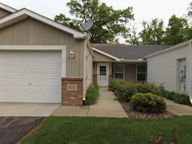 14257 184th Ave NW, Elk River, MN 55330 - single story home with asphalt driveway, a garage, brick siding, roof with shingles, and board and batten siding