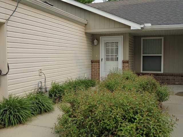 14257 184th Ave NW, Elk River, MN 55330 - view of exterior entry with brick siding and a shingled roof
