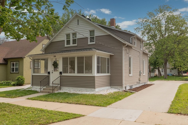 1126 7th Ave SE, Rochester, MN 55904 - bungalow-style house with entry steps, driveway, a chimney, and a front lawn
