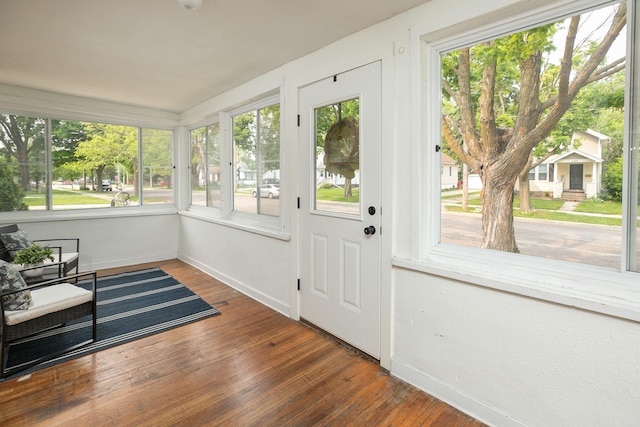 1126 7th Ave SE, Rochester, MN 55904 - unfurnished sunroom featuring baseboards and wood finished floors