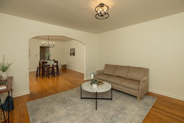 1126 7th Ave SE, Rochester, MN 55904 - living area with arched walkways, a chandelier, and wood finished floors