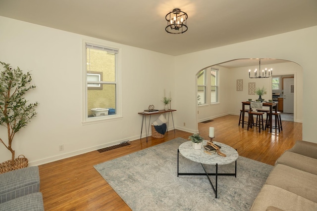 1126 7th Ave SE, Rochester, MN 55904 - living area with a chandelier, arched walkways, and wood finished floors