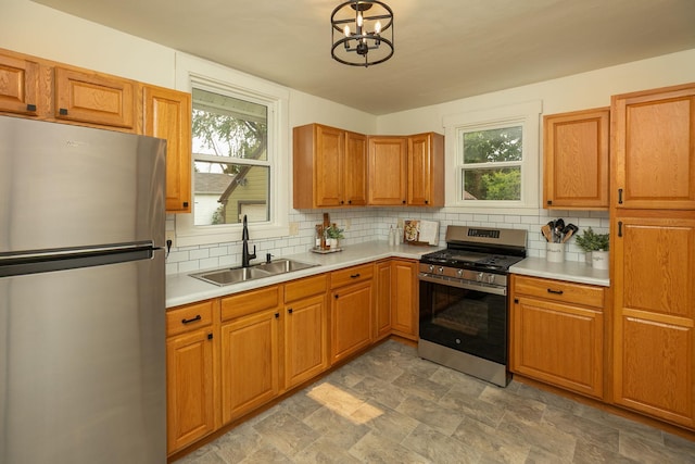 1126 7th Ave SE, Rochester, MN 55904 - kitchen featuring stainless steel appliances, decorative backsplash, light countertops, and healthy amount of natural light