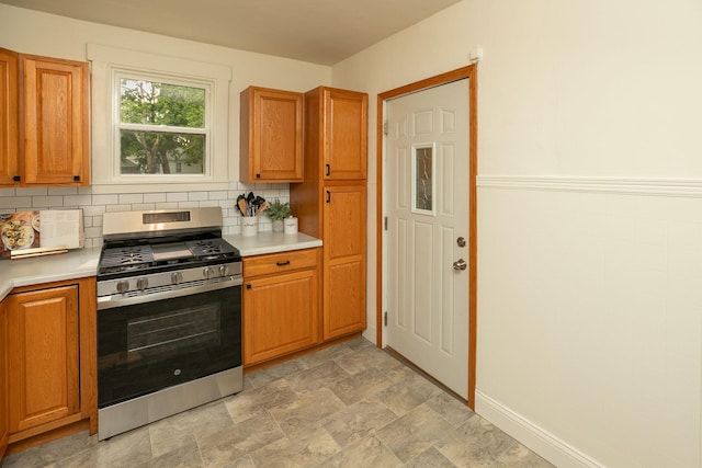 1126 7th Ave SE, Rochester, MN 55904 - kitchen featuring stainless steel gas range, light countertops, brown cabinets, and tasteful backsplash