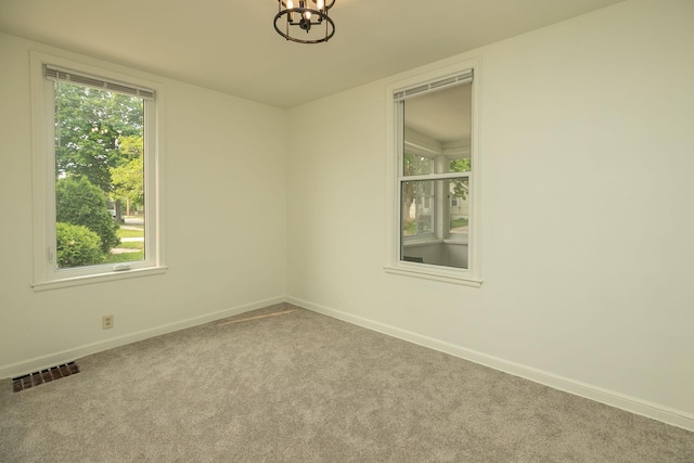 1126 7th Ave SE, Rochester, MN 55904 - carpeted spare room featuring a chandelier and baseboards