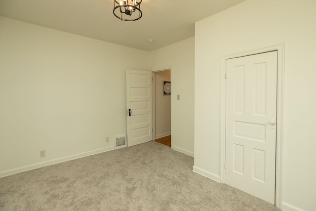 1126 7th Ave SE, Rochester, MN 55904 - carpeted empty room with a chandelier and baseboards