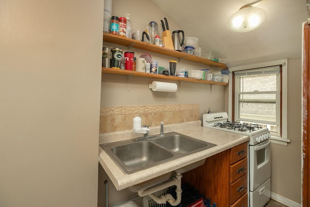 1126 7th Ave SE, Rochester, MN 55904 - kitchen with white range with gas cooktop, light countertops, and brown cabinets