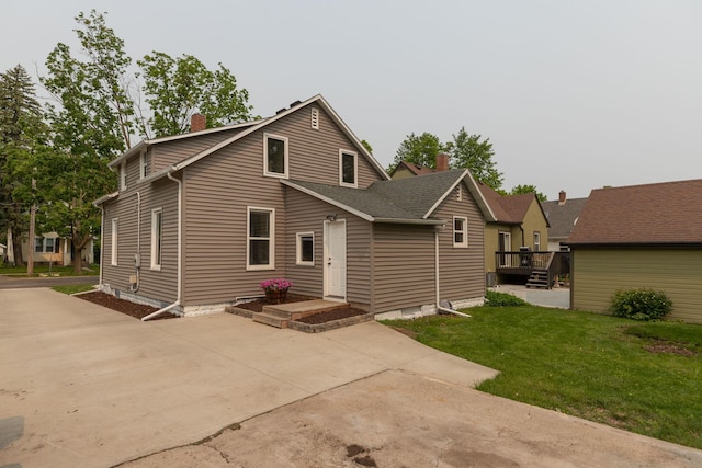 1126 7th Ave SE, Rochester, MN 55904 - back of house with a yard, a chimney, a wooden deck, and driveway