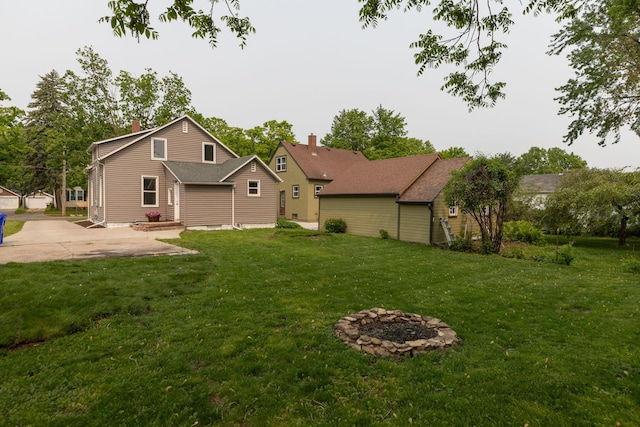 1126 7th Ave SE, Rochester, MN 55904 - rear view of property with a lawn and an outdoor fire pit