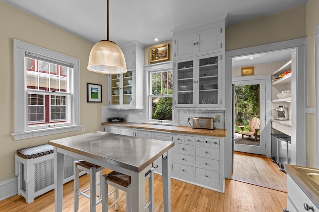 4817 Emerson Ave S, Minneapolis, MN 55419 - kitchen featuring glass insert cabinets, light wood-style floors, light countertops, tasteful backsplash, and recessed lighting