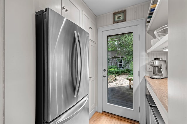 4817 Emerson Ave S, Minneapolis, MN 55419 - kitchen with freestanding refrigerator, light countertops, light wood-type flooring, white cabinetry, and open shelves
