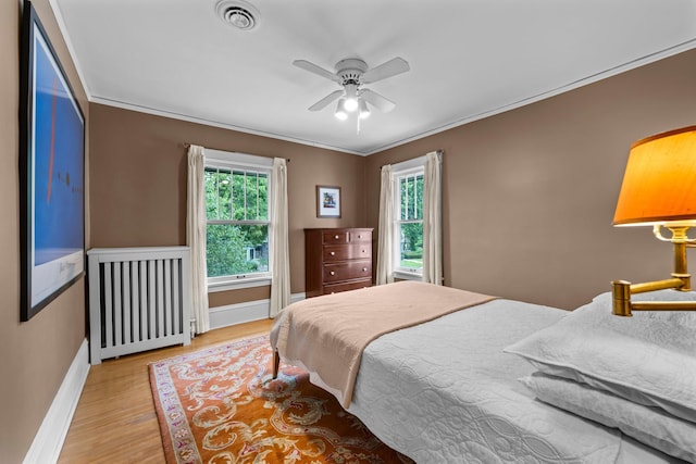 4817 Emerson Ave S, Minneapolis, MN 55419 - bedroom with radiator heating unit, light wood-type flooring, ornamental molding, and ceiling fan