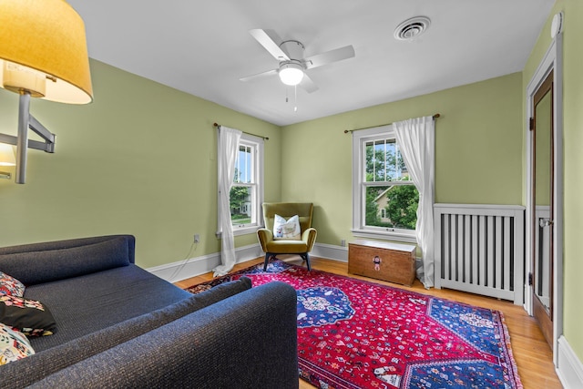 4817 Emerson Ave S, Minneapolis, MN 55419 - living room featuring wood finished floors, ceiling fan, and radiator
