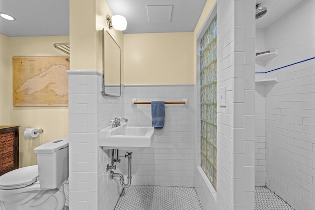4817 Emerson Ave S, Minneapolis, MN 55419 - bathroom with a wainscoted wall, a tile shower, tile walls, and tile patterned floors