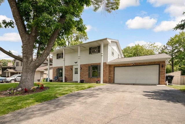 569 Driftwood Rd, New Brighton, MN 55112 - traditional-style home with brick siding, asphalt driveway, a garage, and a front lawn
