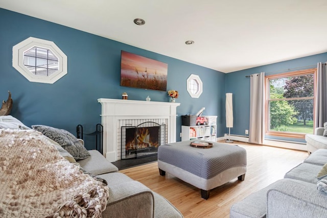569 Driftwood Rd, New Brighton, MN 55112 - living room featuring wood finished floors, a brick fireplace, baseboard heating, recessed lighting, and baseboards