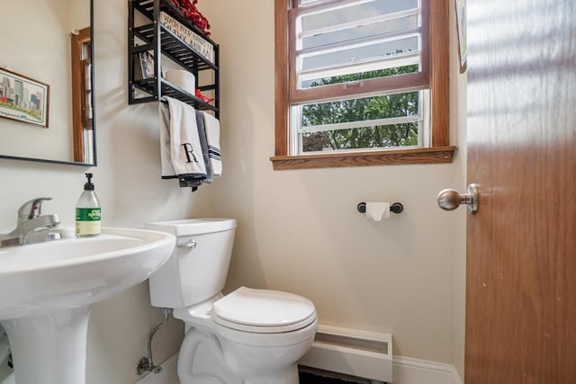 569 Driftwood Rd, New Brighton, MN 55112 - half bathroom featuring toilet and a baseboard heating unit