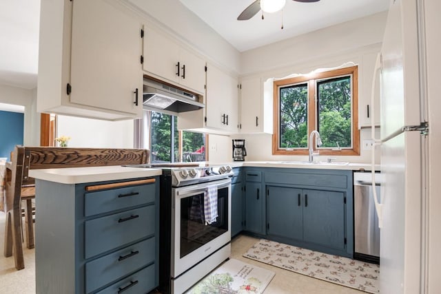 569 Driftwood Rd, New Brighton, MN 55112 - kitchen with appliances with stainless steel finishes, under cabinet range hood, a sink, ceiling fan, and light countertops