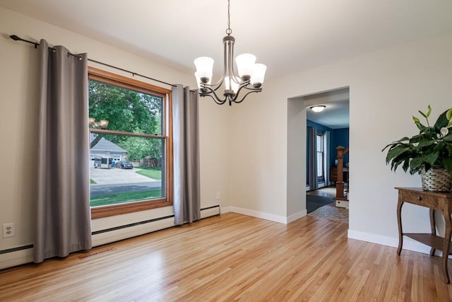 569 Driftwood Rd, New Brighton, MN 55112 - empty room with light wood-style floors, a chandelier, and baseboards