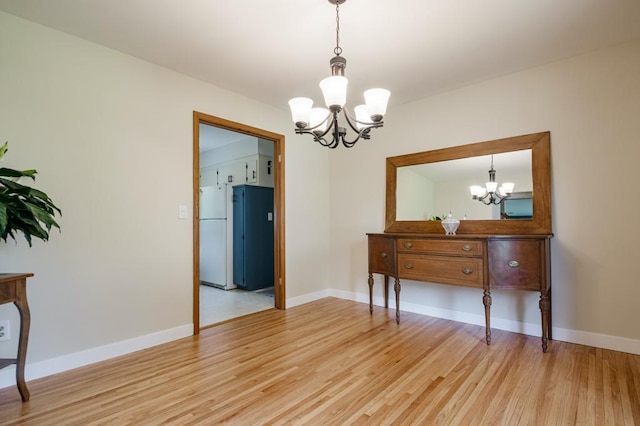569 Driftwood Rd, New Brighton, MN 55112 - dining area featuring a chandelier, light wood-style flooring, and baseboards