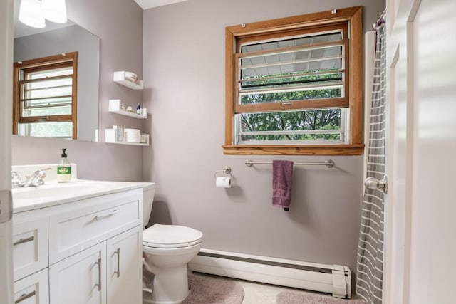 569 Driftwood Rd, New Brighton, MN 55112 - bathroom featuring baseboard heating, toilet, vanity, and tile patterned floors