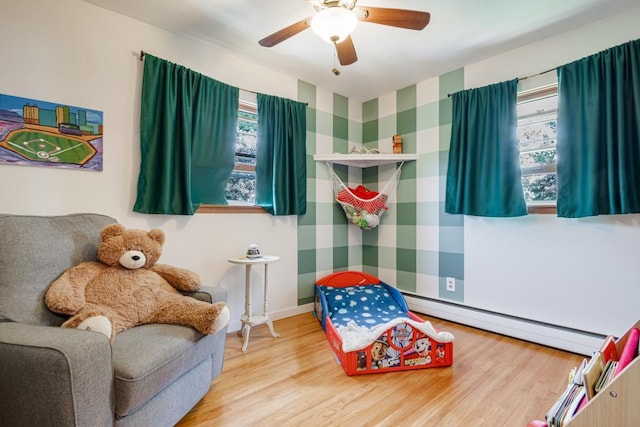 569 Driftwood Rd, New Brighton, MN 55112 - sitting room featuring baseboard heating, wood finished floors, and a ceiling fan