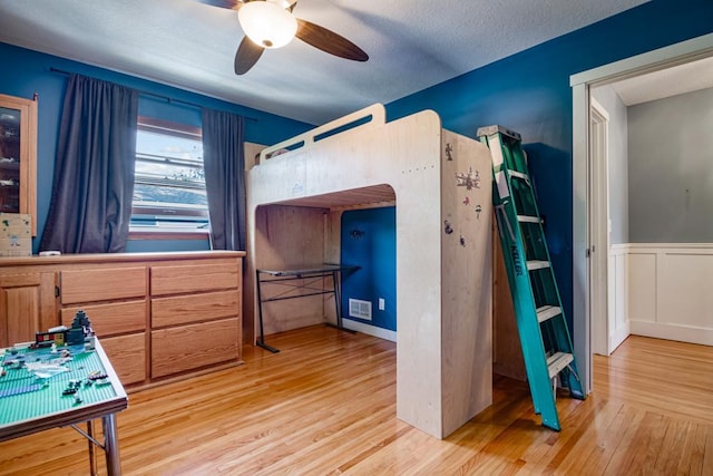 569 Driftwood Rd, New Brighton, MN 55112 - bedroom featuring wood finished floors, wainscoting, and ceiling fan