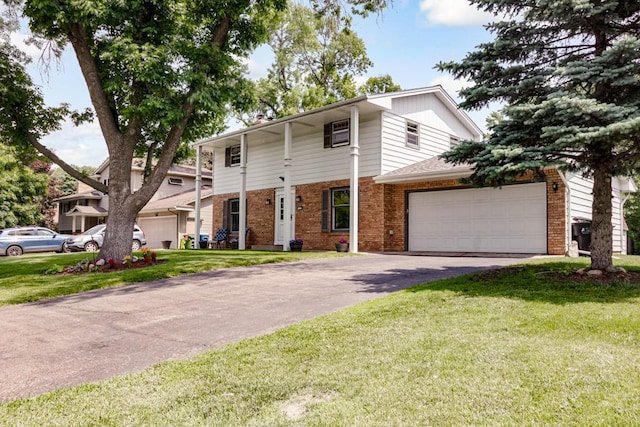 569 Driftwood Rd, New Brighton, MN 55112 - view of front facade featuring brick siding, driveway, an attached garage, and a front yard