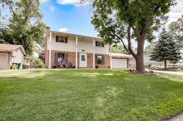 569 Driftwood Rd, New Brighton, MN 55112 - view of front of home featuring brick siding, a front yard, a chimney, and a detached garage