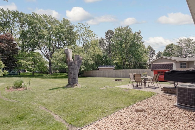 569 Driftwood Rd, New Brighton, MN 55112 - view of yard featuring cooling unit, a patio area, a fire pit, and view of wooded area