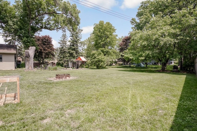 569 Driftwood Rd, New Brighton, MN 55112 - view of green lawn with an outdoor fire pit