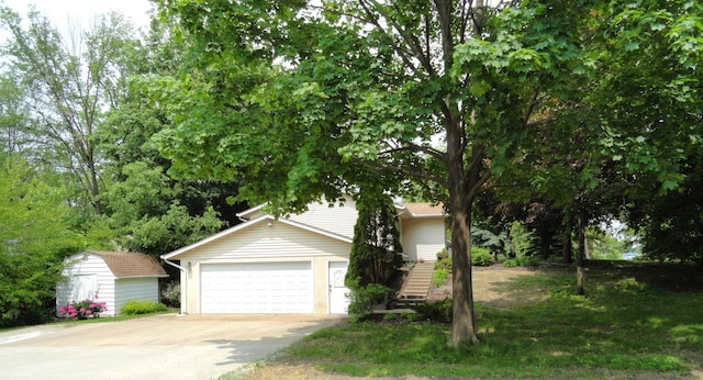 9540 24th Ave N, Plymouth, MN 55441 - view of property hidden behind natural elements featuring driveway and a garage