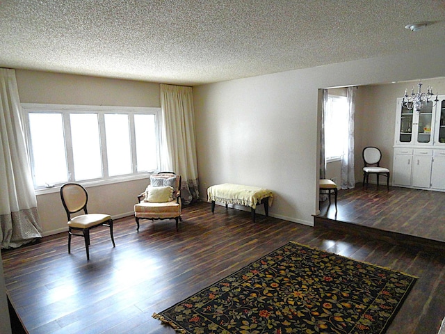 9540 24th Ave N, Plymouth, MN 55441 - living area featuring healthy amount of natural light, wood finished floors, a textured ceiling, and baseboards