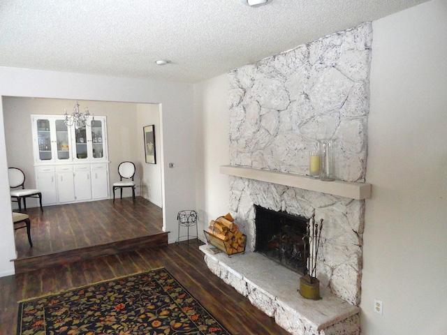 9540 24th Ave N, Plymouth, MN 55441 - living area with wood finished floors, a textured ceiling, a chandelier, and a fireplace