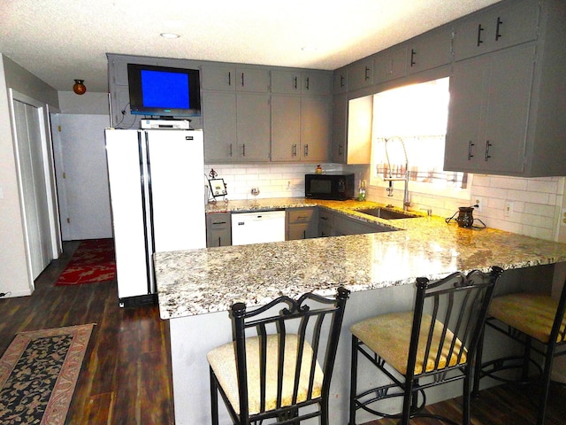 9540 24th Ave N, Plymouth, MN 55441 - kitchen with white appliances, a peninsula, dark wood-style floors, and tasteful backsplash