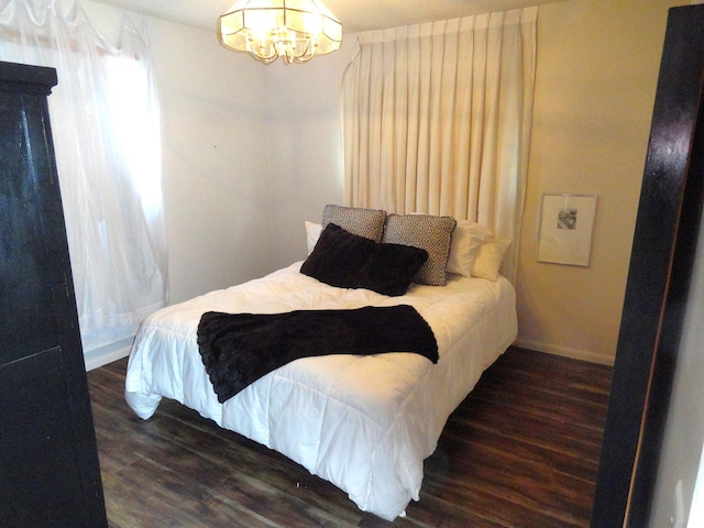 9540 24th Ave N, Plymouth, MN 55441 - bedroom with a chandelier, wood finished floors, and baseboards