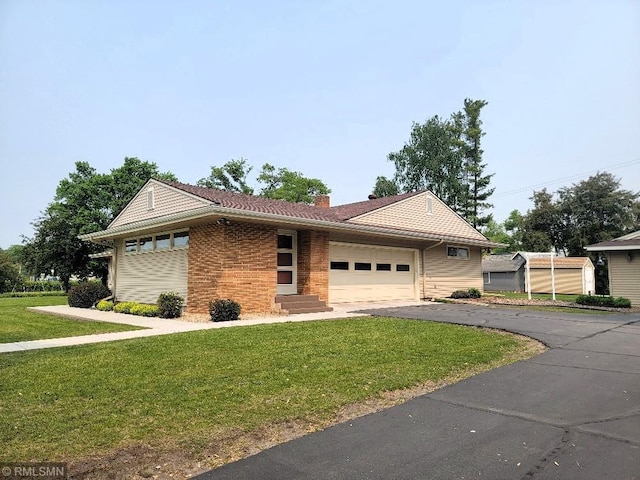 109 Jackson St W, Eagle Bend, MN 56446 - single story home with a front yard, a garage, driveway, and brick siding
