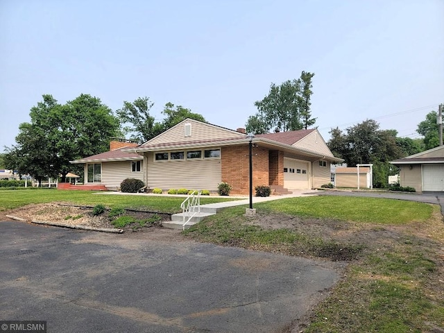 109 Jackson St W, Eagle Bend, MN 56446 - ranch-style home with an attached garage, asphalt driveway, a front yard, and a chimney