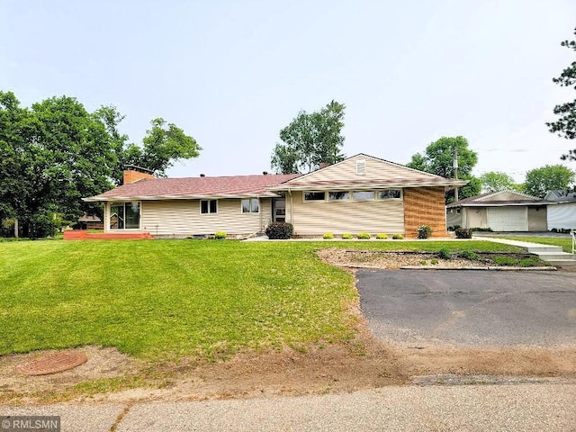 109 Jackson St W, Eagle Bend, MN 56446 - ranch-style house featuring a front yard and a chimney