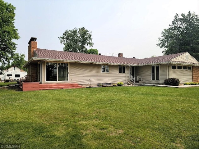 109 Jackson St W, Eagle Bend, MN 56446 - back of house with a chimney, a yard, and a garage