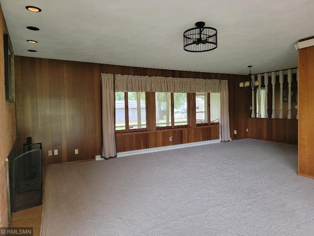 109 Jackson St W, Eagle Bend, MN 56446 - unfurnished living room featuring wood walls, carpet, and baseboards