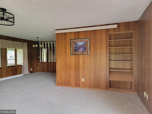 109 Jackson St W, Eagle Bend, MN 56446 - carpeted empty room featuring wood walls and built in shelves