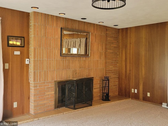 109 Jackson St W, Eagle Bend, MN 56446 - unfurnished living room with wood walls, a brick fireplace, and carpet floors