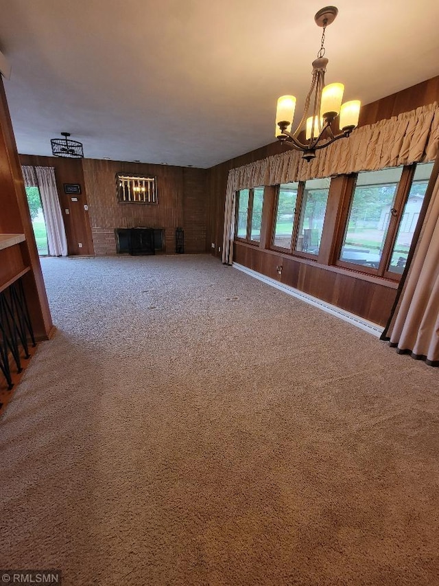 109 Jackson St W, Eagle Bend, MN 56446 - unfurnished living room with a chandelier, carpet floors, a fireplace, and wooden walls