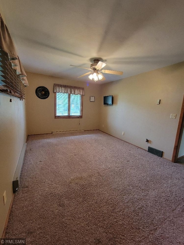 109 Jackson St W, Eagle Bend, MN 56446 - unfurnished room with a ceiling fan, carpet flooring, and a baseboard radiator