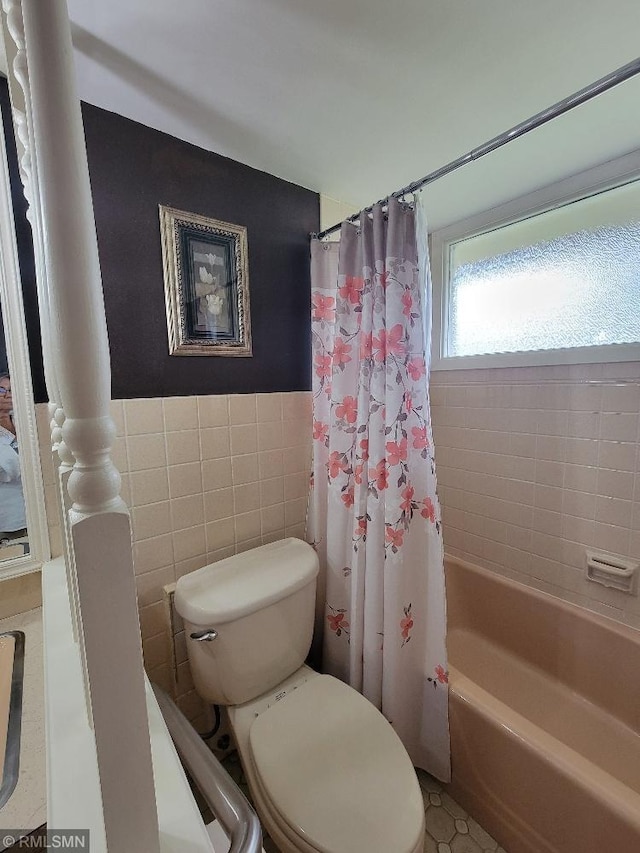 109 Jackson St W, Eagle Bend, MN 56446 - bathroom with toilet, tile walls, and shower / bath combo with shower curtain