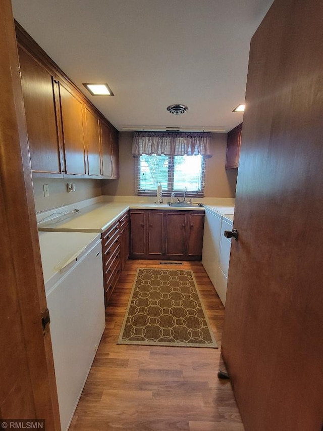 109 Jackson St W, Eagle Bend, MN 56446 - kitchen featuring a sink, wood finished floors, and light countertops